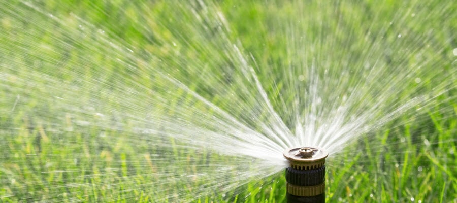 Automated sprinkler system watering lawn