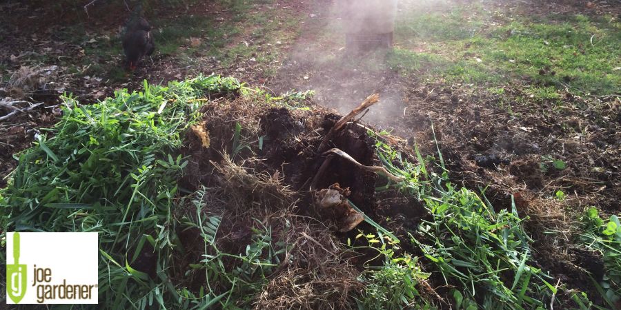 tall pile of brush and compost steaming